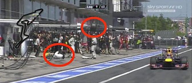 Il pilota della Red Bull Mark Webber riparte dal pit stop mentre i meccanici stanno ancora avvitando la posteriore destra. La gomma si stacca ed investe in pieno un cameraman, durante il Gran Premio di Germania al Nrburgring. Ansa-Sky